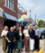 Click Rain Trendigital smiling in front of the giant sundae statue outside of the Wells Visitor Center in Le Mars, Iowa on a sunny day.