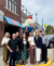 Click Rain Trendigital smiling in front of the giant sundae statue outside of the Wells Visitor Center in Le Mars, Iowa on a sunny day.