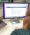 Click Rain Associate Director of Marketing, Bailey Wood, using Google Gemini at her desk.