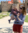 Female employee smiles while holding her son in front of castle during the summer