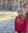 Genna smiling while standing in front of a rocky cliff and frozen river.