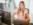 Female employee sitting at her desk working on the computer and smiling