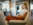 Side profile image of female employee sitting in a comfortable chair with a laptop in her lap.