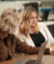 Liv and Chelsea collaborate with laptops at HQ