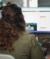 Over the shoulder shot of woman at her desk looking at a website